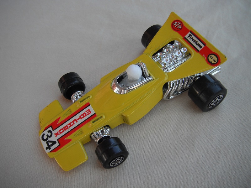 7. Yellow body/unpainted Speedkings base/wider rear wheels/white driver w/white helmet/&quot;Matchbox 34&quot; wht lbls/no side lbls.