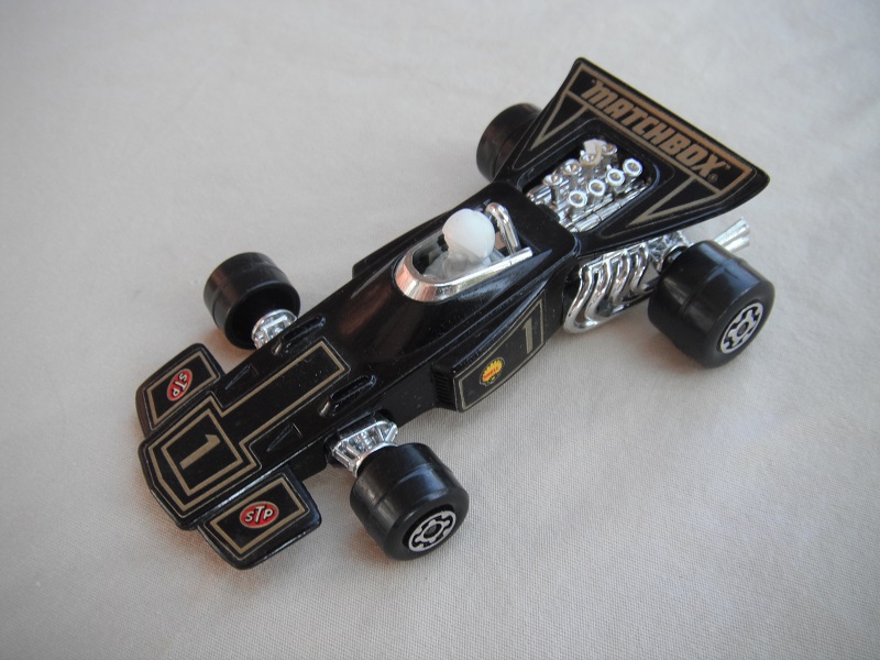 2. Black body/unpainted Speedkings base/large rear wheels/white driver w/white helmet/&quot;Matchbox 1&quot; labels.