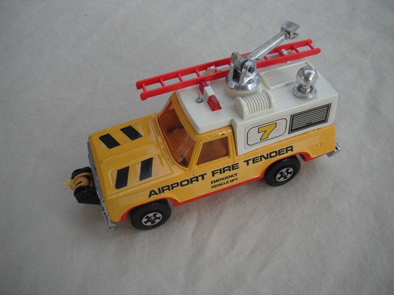 5. Yel body/wht canopy/red base/red dome lts/red ladder/amber windows/sml steering/&quot;Airport Fire Tender&quot;/7 &amp; stripes label/yel cable.