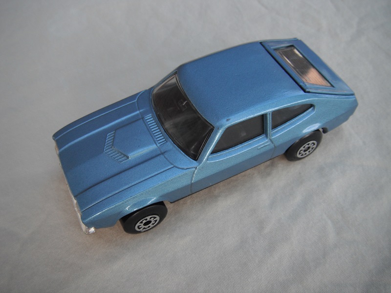 B12.Metallic light blue body/black superkings base/5 arch wheels/black interior/clear windows.