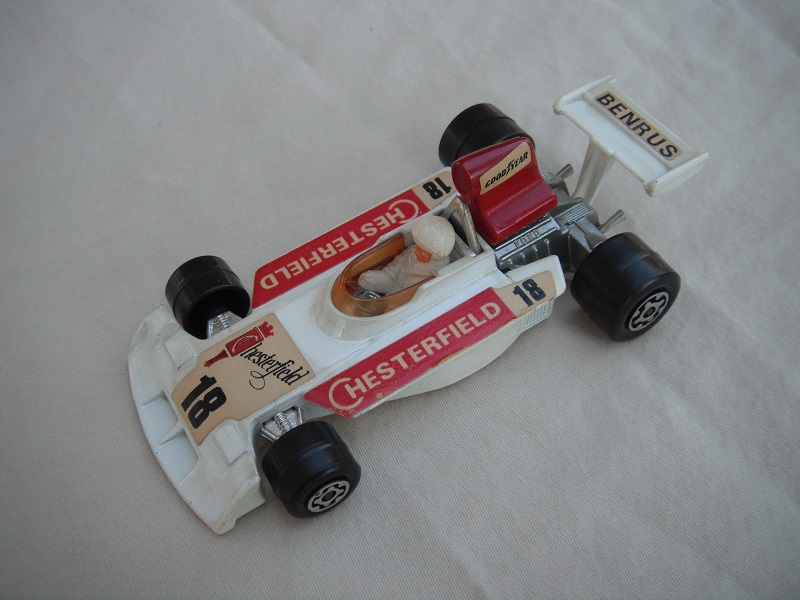 7. Wht body/very dk.red spoiler/wht Speedkings base/amb wind/lrg wide rear whls/wht driver(exposed face)/lrg wht helmet/red Chesterfield 18/Benrus &amp; Goodyear lbls.