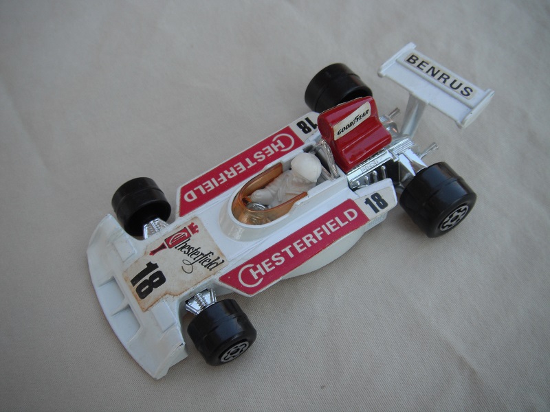 6. Wht body/dk.red spoiler/wht Speedkings base/dk.amb wind/rg wide rear whls/wht driver w/lrg wht helmet/dk.red Chesterfield 18/Benrus &amp; Goodyear&quot; lbls.