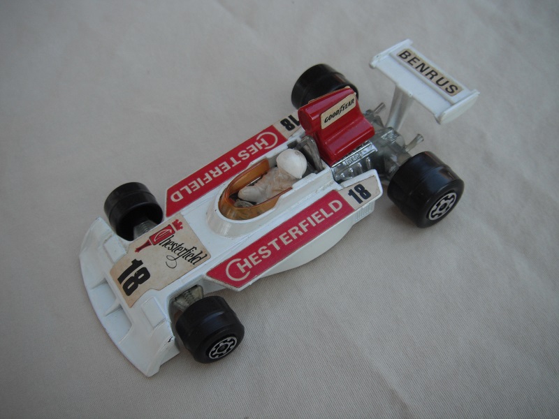 5. Wht body/dk.red spoiler/wht Speedkings base/amb wind/lrg wide rear wheels/wht driver w/lrg wht helmet/red Chesterfield 18/Benrus &amp; Goodyear lbls.