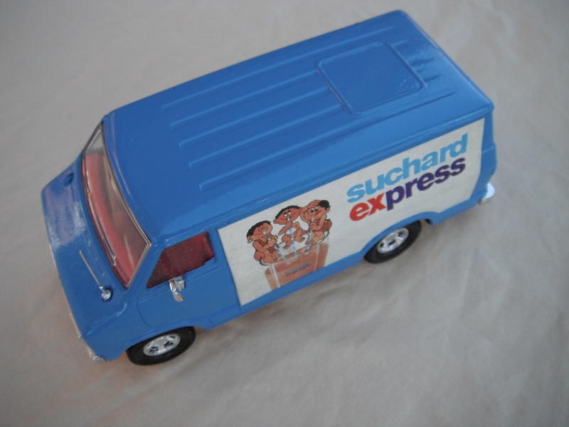 9. Blue body/black base/red interior/clear windows/no chrome outline around windshield/Suchard Express labels.