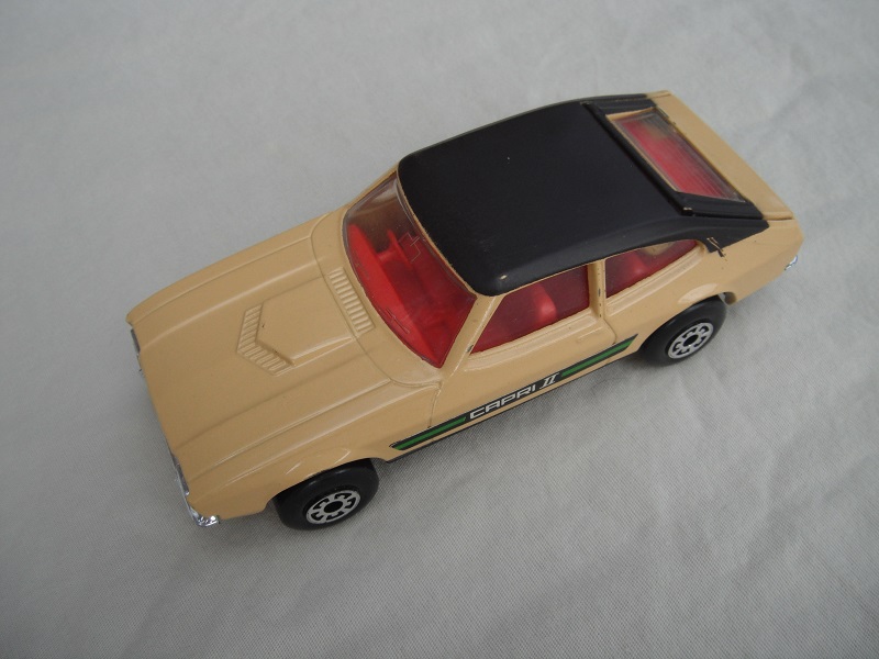 E13.Tan body/dk.brown roof/matt blk speedkings base/5 arch whls/red interior/clr windows/green Capri 11 side labels.