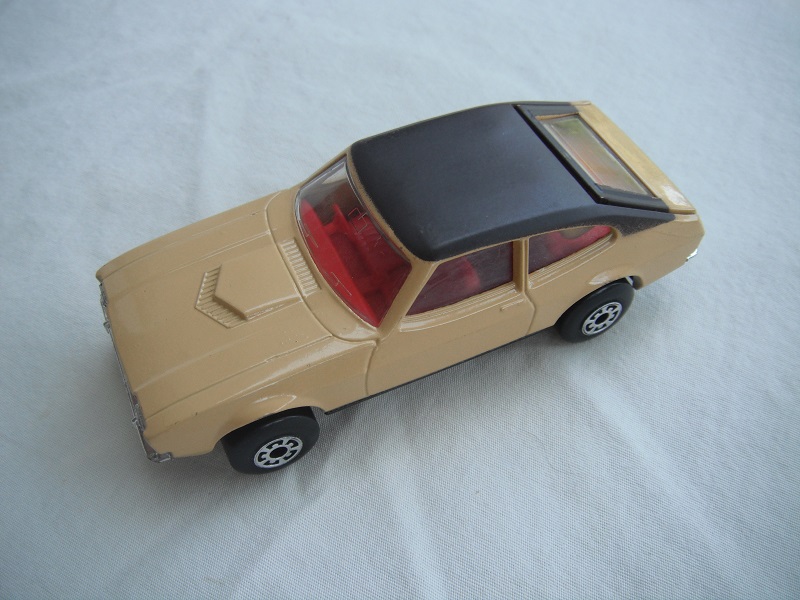 E11.Tan body/black roof/matt blk superkings base/5 arch wheels/red interior/clear windows.