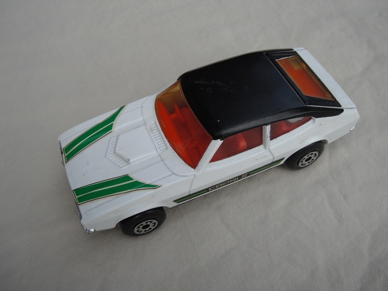 E4. White body/blk roof/matt blk speedkings base/5 arch whls/red int/amb windows/green Capri 11 &amp; stripe labels.