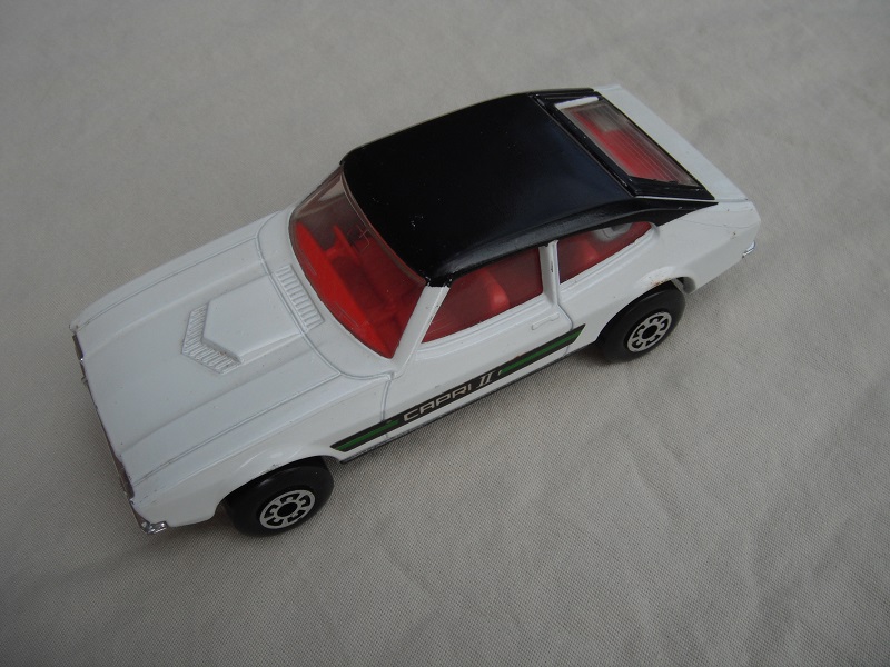 E2. White body/blk roof/matt blk speedkings base/5 arch whls/red interior/clear windows/green Capri 11 labels.