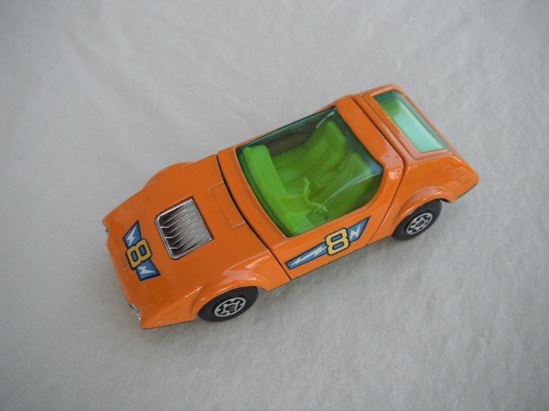 7. Dark orange body/metallic green base/MC wheels/yellow interior/green windows/&quot;8&quot; in orange.