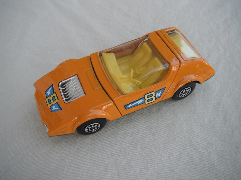 4. Orange body/metallic green base/MC wheels/yellow interior/clear windows/&quot;8&quot; in orange.