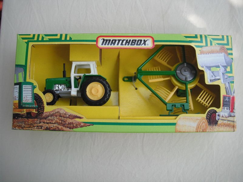 6. Grn tractor/wht canopy/sil base/China/lt.yel hubs/Rotary rake w/dk.green frame/lt.yellow rakes &amp; hubs/unpainted base/steel axle/wide tow eye.