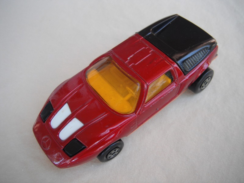 Br2. Burgundy body/dk.orange base/5 spoke wheels/amber windows/white interior/black headlights/England base.