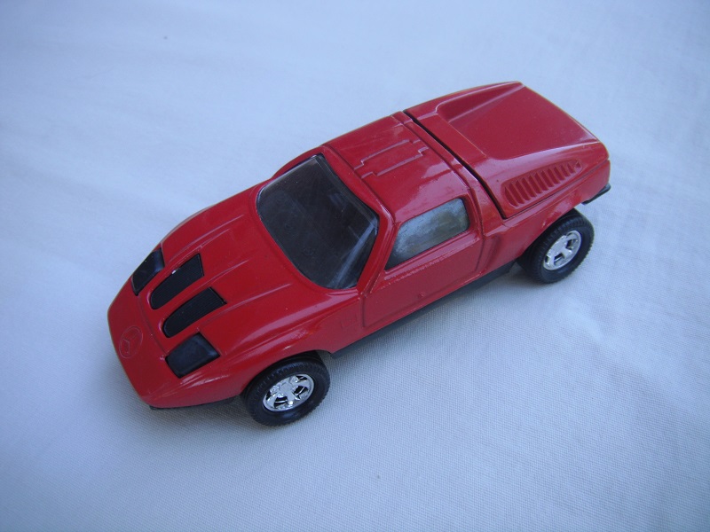 B6. Dark red body/black base/five spoke mag wheels/clear windows/black interior &amp; headlights.