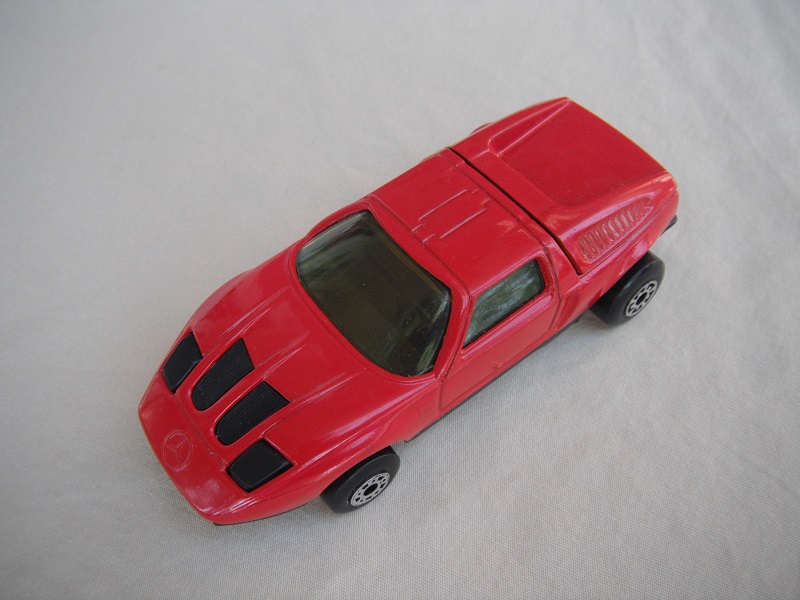 B5. Dk.red body/black base/dot-dash front, five arch rear whls/lt.amber windows/black interior &amp; headlights.
