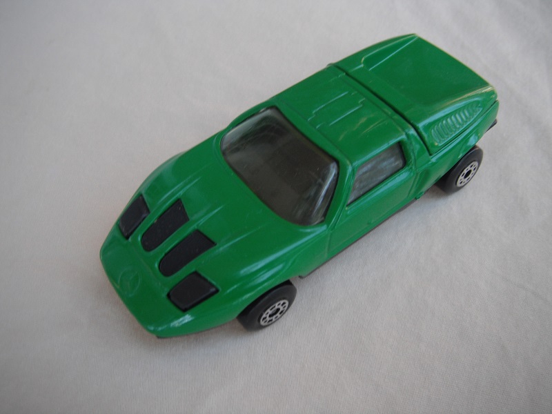 B3. Dark green body/black base/dot-dash wheels/clear windows/black interior &amp; headlights.