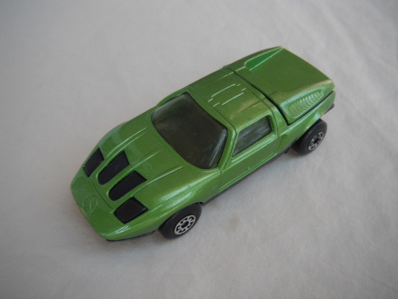 B2. Dark lime green body/black base/five arch wheels/clear windows/black interior &amp; headlights.