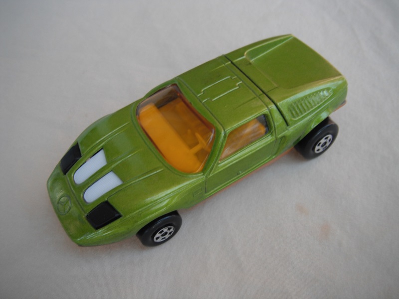 E18. Lime green body/very dark gold base/five spoke wheels/amber windows/white interior/black headlights.
