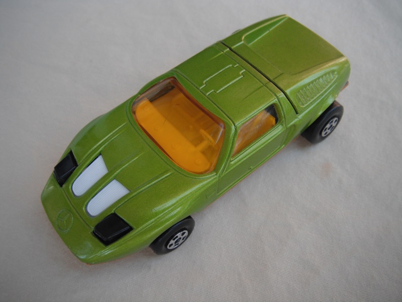 E15. Lime green body/light gold base/five spoke wheels/amber windows/white interior/black headlights.