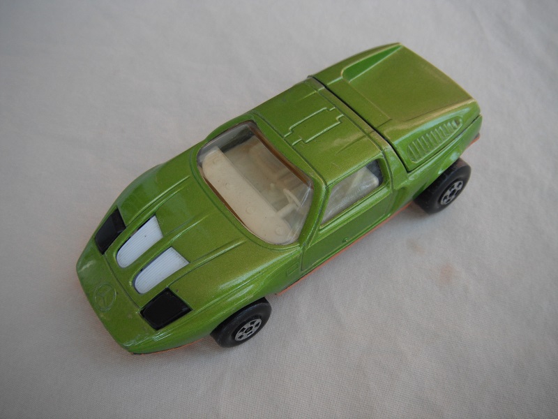 E13. Lime green body/gold base/five spoke wheels/lt.amber windows/white interior/black headlights.
