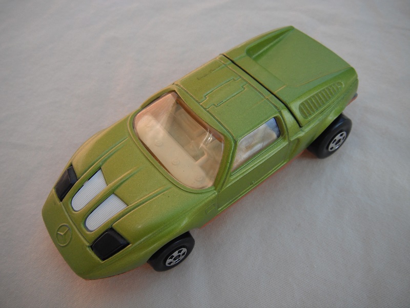 E11. Lt. lime green body/gold base/five spoke wheels/lt.amber windows/white interior/black headlights.