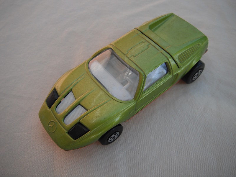 E9. Lime green body/light gold base/five spoke wheels/clear windows/white interior/black headlights.