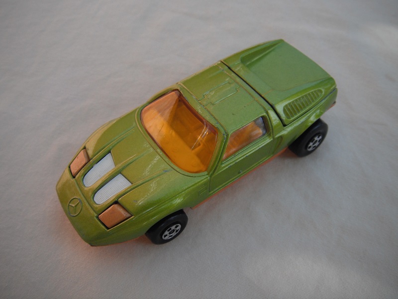 E6. Lime green body/dark orange base/five spoke wheels/amber windows/white interior/dark gold headlights.