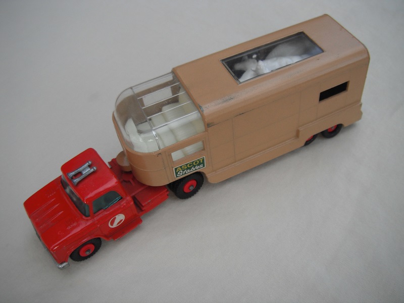 6. Red cab/type B base/dk.red horse decal/tan trailer type B/dk.green Ascot Stables label/type B rear door/red axle spring/olive green interior.