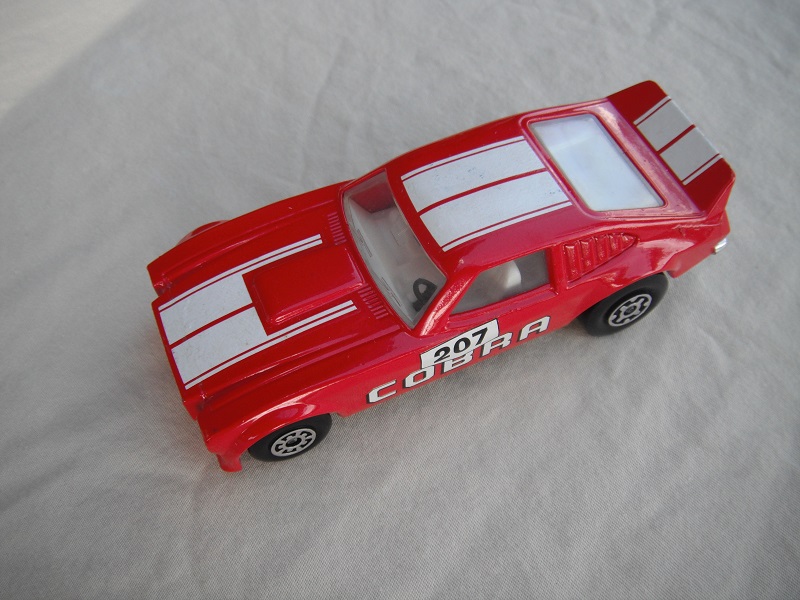 6. Red body/white stripes/black Superkings base/clear windows/white int/207 Cobra side decals.