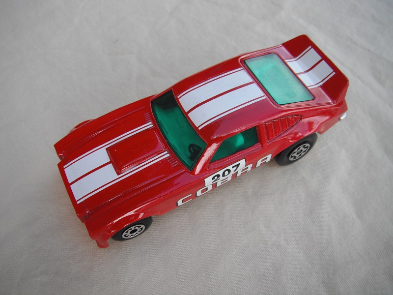 4. Dark red body/white stripes/black Superkings base/green windows/207 Cobra side decals.