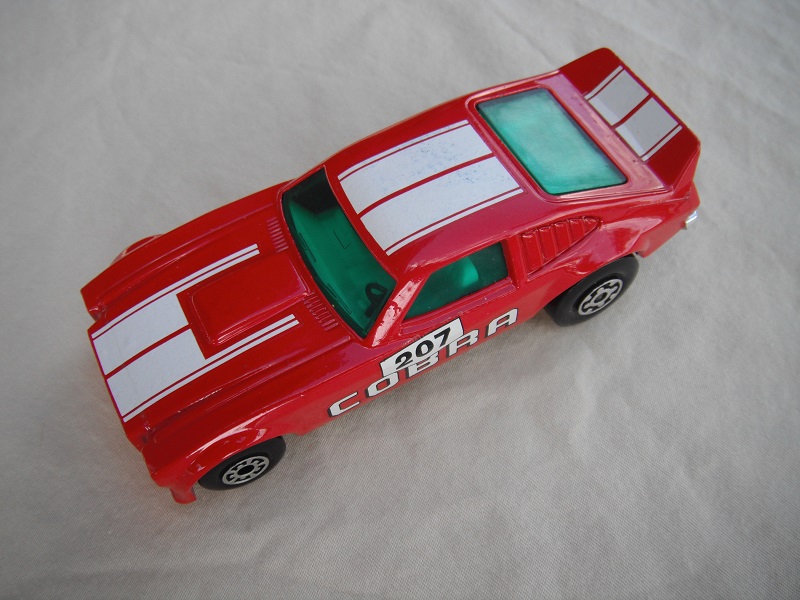 3. Red body/white stripes/black Superkings base/green windows/white int/207 Cobra side decals.