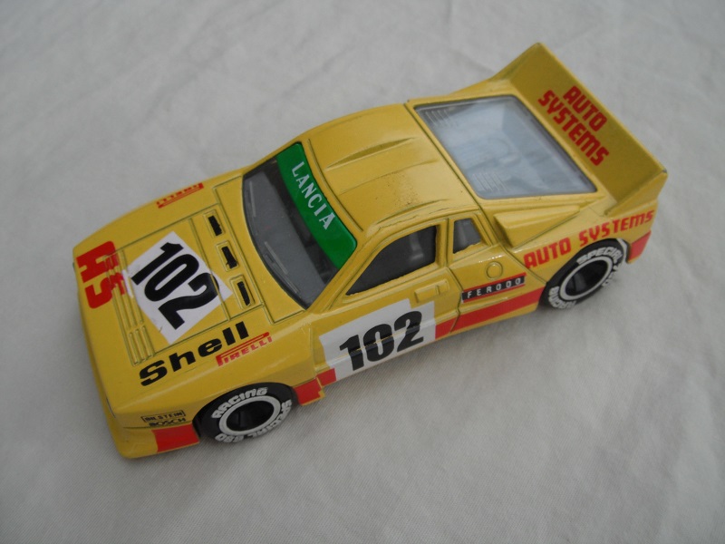 5. Yellow body/red stripe/black base Macau/clear windows/gray int/chromed lettering on wheels/large rear wheels/Auto Systems #102.