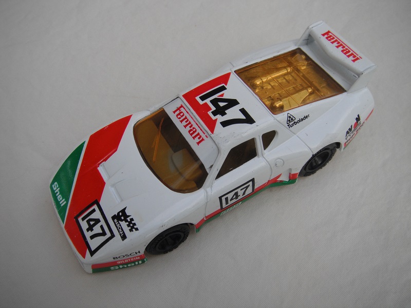 14.White, dk.green &amp; dk.red body/var.racing logos/black base China/dk.gray int/amber windows &amp; headlights/unchromed whls/&quot;Ferrari 147&quot;.