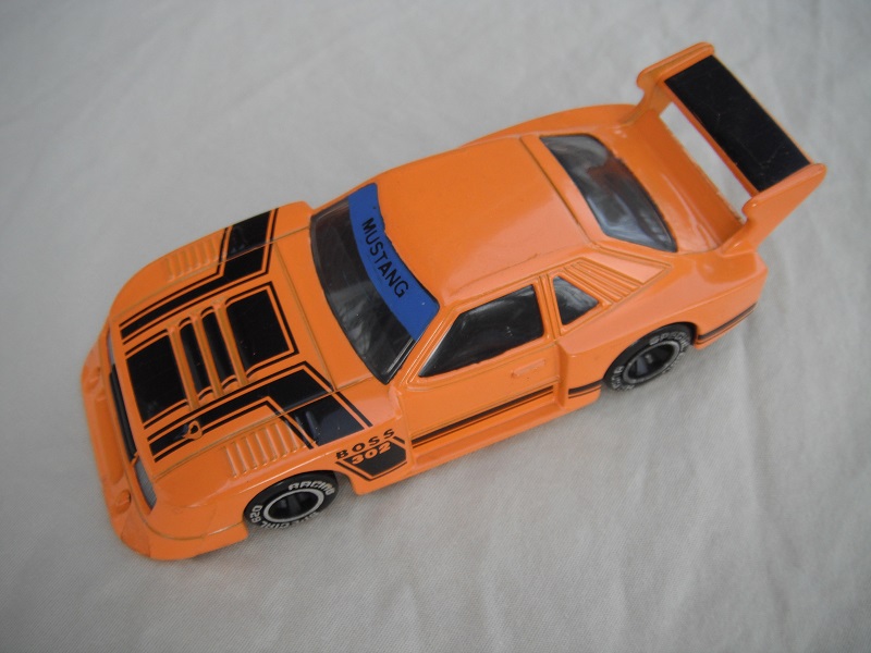 16.Dk.orange body with black stripes/black base China/clear windows/black interior/chromed lettering on wheels/Boss 302.