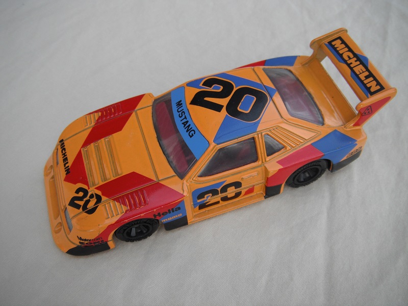 4. Lt.orange body/dk.red stripe/black base China/clear windows/red interior/unchromed wheels/large Michelin on rear spoiler/#20.