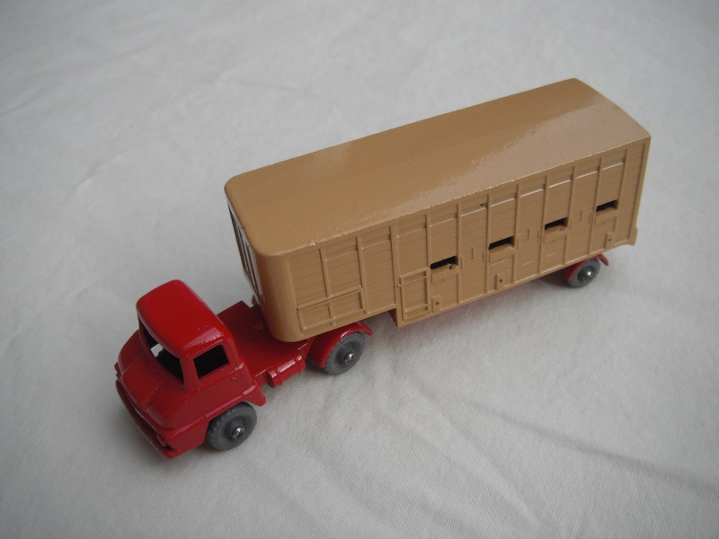 1. Bright red cab/type A/DGKW/silver trim/lt.tan trailer type A/red base/type A external/type A internal/rear cross frame type A/lt.tan rear door.