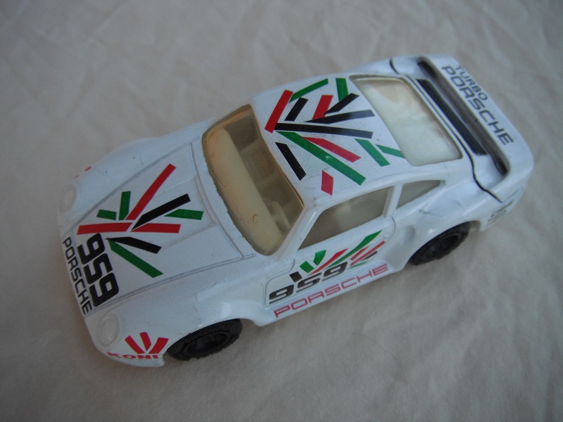 11.White body with blk/grn/red graphics/white base China/white interior/lt.amber windows/unchromed wheels/Porsche 959.