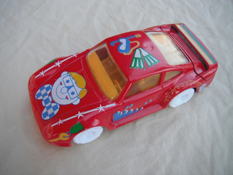9. Red body/black base China/dark yellow interior/clear windows/white wheels/kids graphics.
