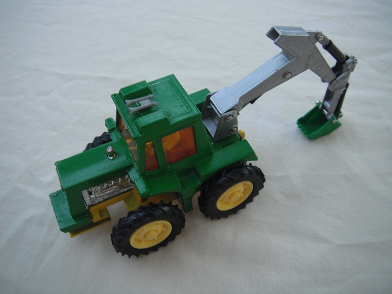 25.Green tractor/no plow/silver backhoe &amp; green scoop/amber windows/thin tires/light yellow hubs/dark yellow base/red int/1984 China cast.