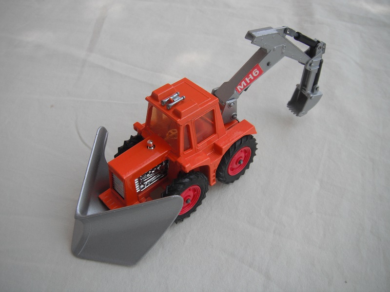 1. Org tractor/sil plow/sil backhoe &amp; scoop/lt.amber wind/thin tires/dk.red hubs/dk.red int/1972 England cast/sil plate above tow hook/MHS lbls/PP.