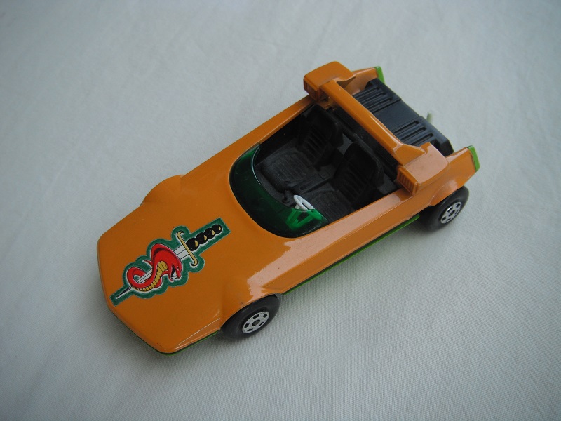 5. Orange body/lime green base/Speedkings/green windshield/orange cast headlights/white steering wheel/white tow hook/sword &amp; snake label.