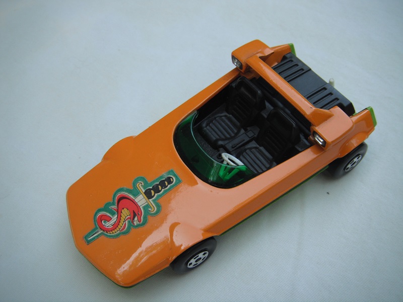 4. Orange body/lime green base/Speedkings/green windshield/chrome headlights/white steering wheel/white tow hook/sword &amp; snake label.