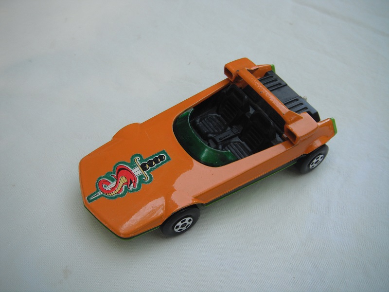 1. Dk.orange body/dk.lime green base/Speedkings/green windshield/no headlights/no steering wheel/white tow hook/sword &amp; snake label/PP.