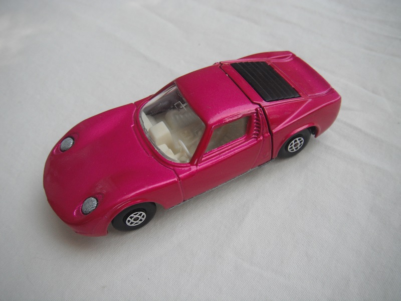 12.Burgundy body/unpainted base/spiro wheels/clear windows/white int/unpainted headlights/no hood label/no tow hook.