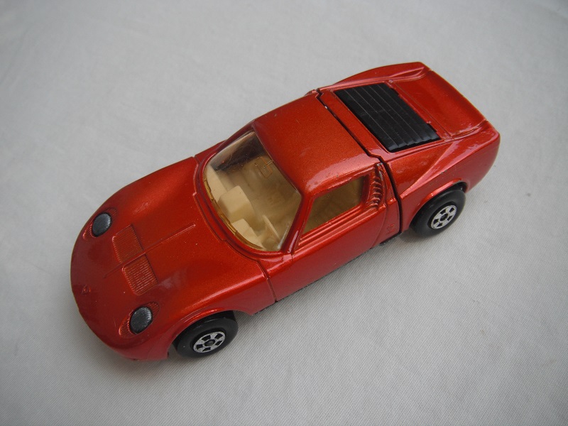 11.Bronze body/unpainted base/5 spoke wheels/lt.amber windows/white int/unpainted headlights/no hood label/no tow hook.