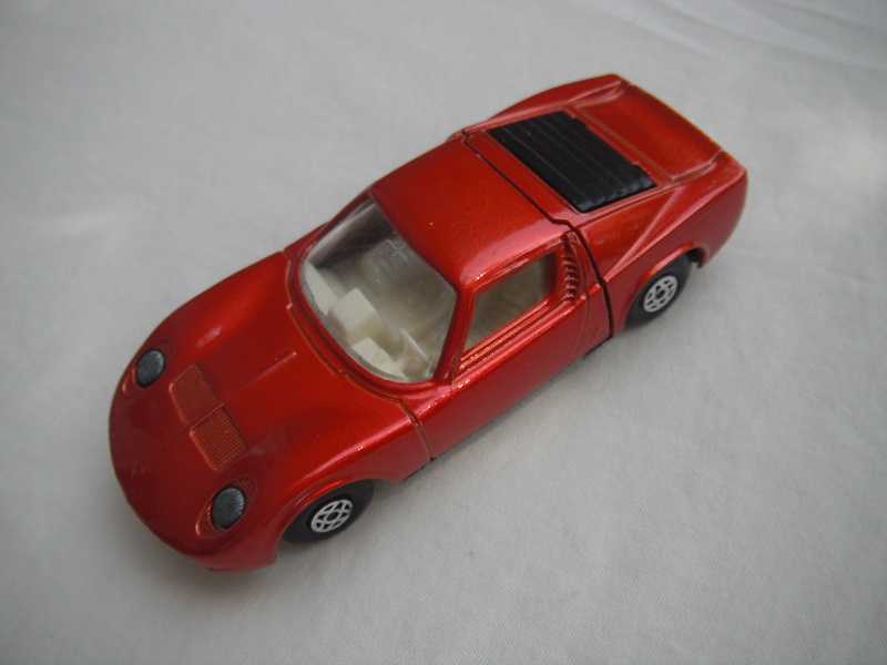 7. Bronze body/unpainted base/spiro wheels/clear windows/white int/unpainted headlights/no hood label/white tow hook.