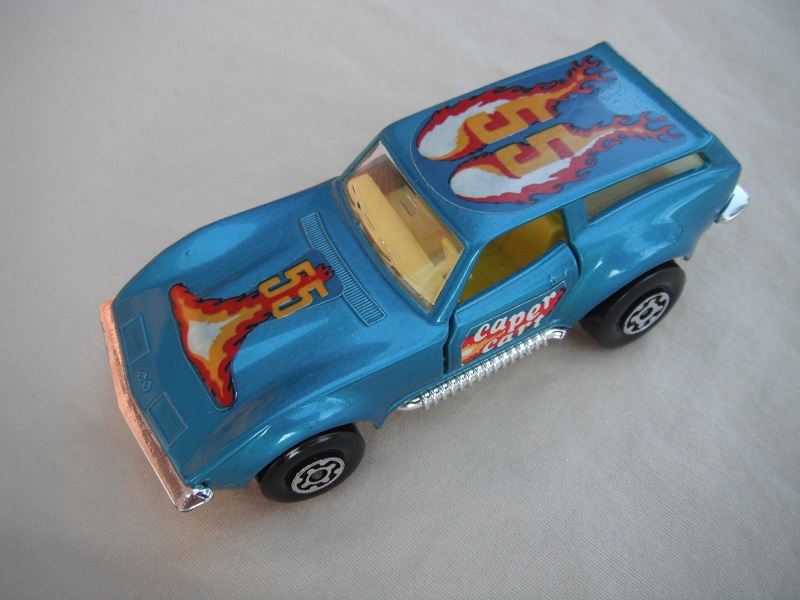 17.Metallic blue body/silver base/Speedkings/MC wheels/clear windows/yellow interior/caper cart on doors/&quot;55&quot; in dk.orange/flames on hood &amp; roof.