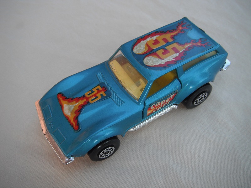 16.Metallic blue body/silver base/Speedkings/MC wheels/clear windows/yellow interior/caper cart on doors/&quot;55&quot; in orange/flames on hood &amp; roof.