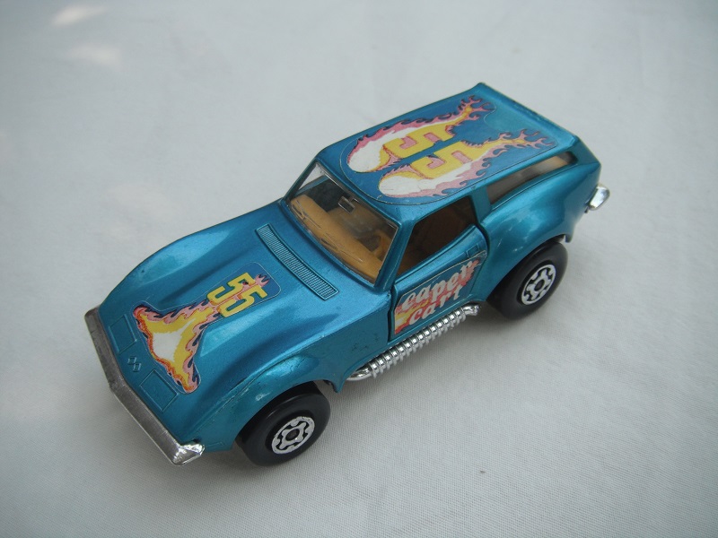 15.Metallic blue body/silver base/Speedkings/MC wheels/clear windows/dk.yellow int/caper cart on doors/&quot;55&quot; in yellow/flames on hood &amp; roof.