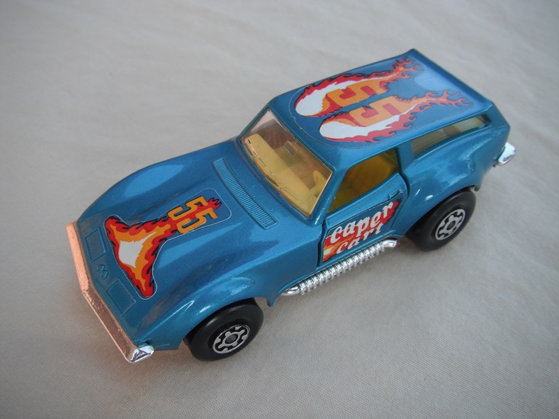 13.Lt.metallic blue body/silver base/Speedkings/MC wheels/clear windows/yellow interior/caper cart on doors/&quot;55&quot; in orange/flames on hood &amp; roof.