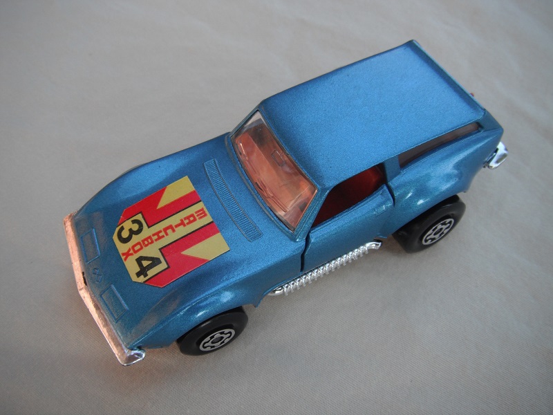 3. Metallic dk.blue/silver base/Superkings/MC wheels/clear windows/reddish brown interior/34 Matchbox label on hood/PP.